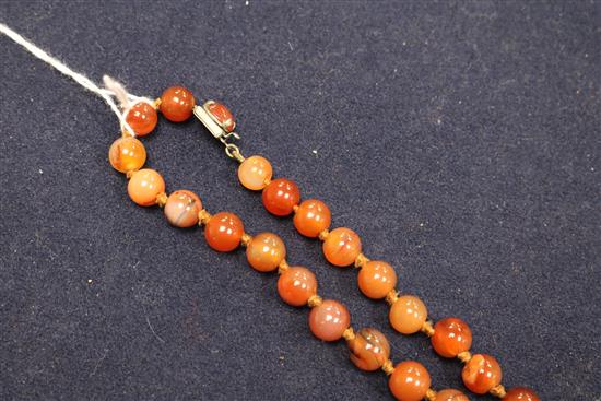 An early 20th century banded agate and other hardstone bead necklace, 80cm.